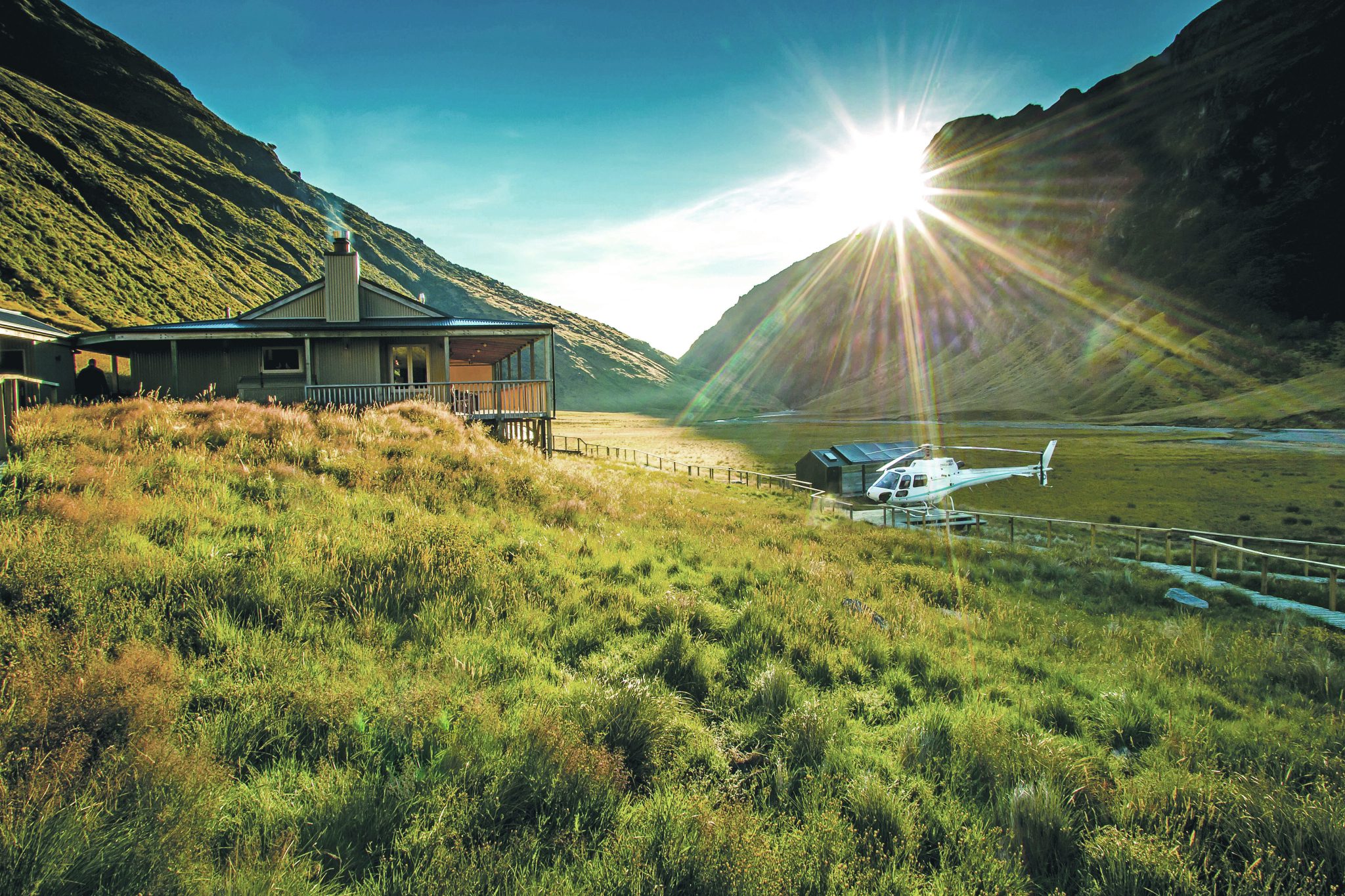 Minaret Station Alpine Lodge,New Zealand,exterior with helicopter and mountains